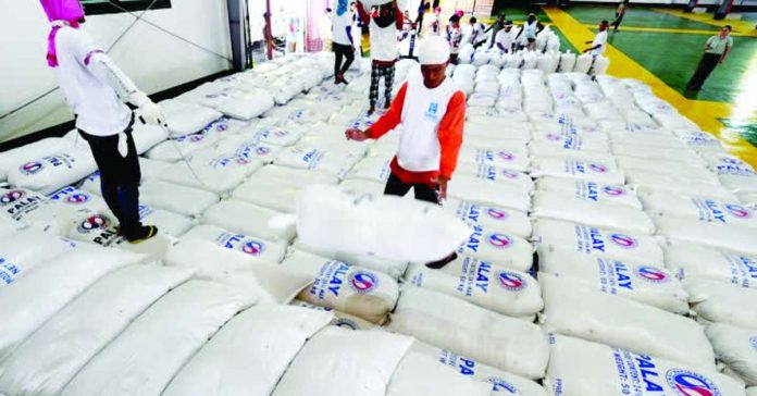 rice_inventory_compressed_resized Warehouse personnel fix rice stocks at a warehouse in Malolos, Bulacan. Rice stocks in National Food Authority depositories fell by 32.2%, from 452.74 thousand metric tons (MT) in August 2025 to 306.82 thousand MT in August 2026.