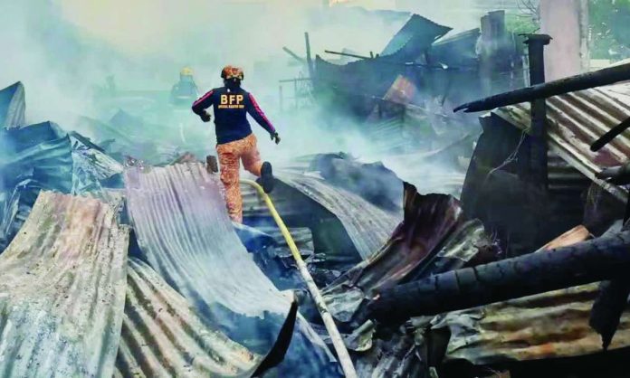 roxas_fire_compressed_resized Firefighters navigate the smoking debris of gutted homes during mop-up operations in Barangay 8, Roxas City. PHOTO COURTESY OF AIO LGU IVISAN/FACEBOOK