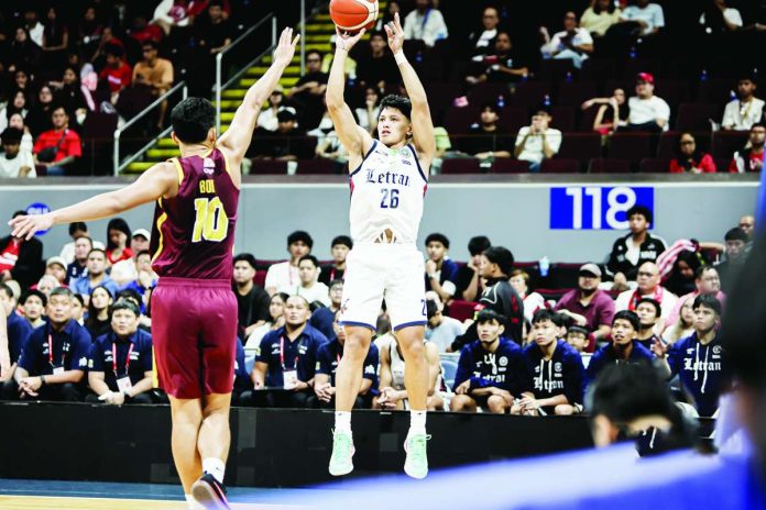 sports_Letran_compressed_resized Colegio de San Juan de Letran Knights guard Johnsherick Estrada pulls up for a three-point attempt during their NCAA Season 102 men’s basketball game. Estrada finished with 18 points, six assists and four rebounds as Letran defeated University of Perpetual Help, 84-77. NCAA