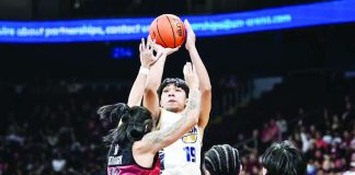 National University Bulldogs’ Mac-Mac Alfanta pulls up for a shot against the defense of University of the Philippines Fighting Maroons’ Rey Remogat. UAAP