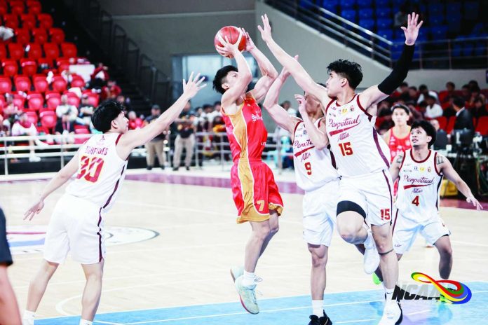 University of Perpetual Help Altas big man Juan Tulabut blocks the shot attempt of San Sebastian College-Recoletos Golden Stags’ Ralph Gabat during their NCAA Season 102 men’s basketball encounter. Tulabut led the Altas with 18 points in their 86-74 victory. NCAA PHOTO