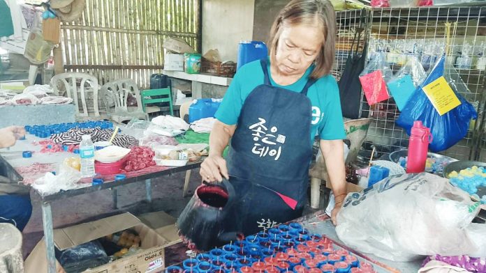 Angela Marbebe of Jordan, Guimaras has spent 26 years making candles. “It really helped us because I became a solo parent to our six children. My husband died when my youngest was only six years old,” she says.