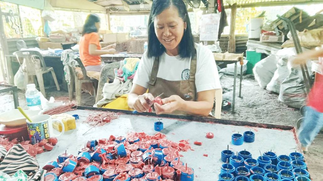Regina Barreto of Barangay Magsaysay, La Paz, Iloilo City learned making candles through training provided by the church. Despite the challenges, she says the job became an important source of income for her family.