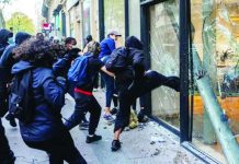 DFA warns Filipinos to avoid protest hotspots in France, Italy; and exercise heightened vigilance Protesters destroy front doors and windows as looting breaks out in several cities in France. GETTY IMAGES