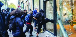 Protesters destroy front doors and windows as looting breaks out in several cities in France. GETTY IMAGES
