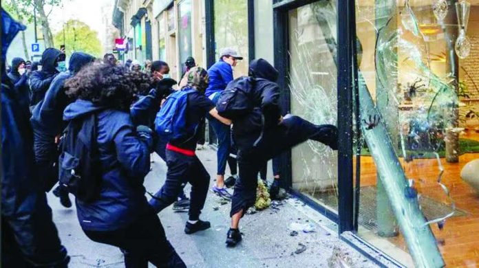 Protesters destroy front doors and windows as looting breaks out in several cities in France. GETTY IMAGES