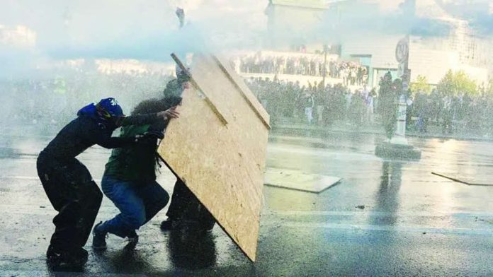France_copy_compressed_resized Police use a water cannon against a protester at a demonstration at Bastille by the student protest movement in Paris, France, on October 8, 2026. Thousands gathered at the Bastille hours before the French government made its first concession to the students. NURPHOTO VIA GETTY IMAGES
