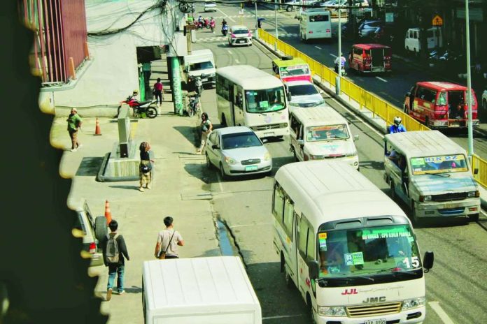 PUV_compressed_resized Traditional and modern public utility vehicles share a busy street in downtown Iloilo City. Facing a massive P1.584B budget cut, the Department of Transportation's transport modernization plan leaves local drivers and small operators deeply concerned about their livelihoods and financial survival. ALLEN ANIMAS/PN