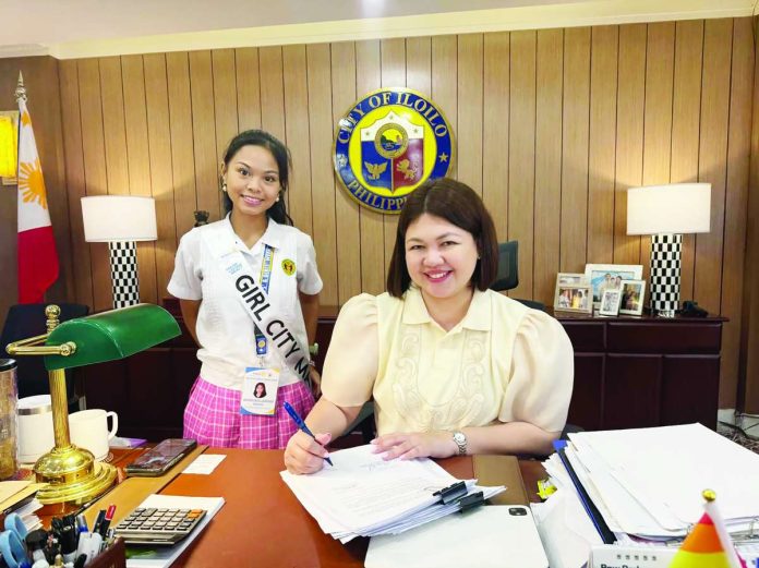 banner_for_oct21_compressed_resized TOWARD A MORE HOLISTIC HOUSING SOLUTION. Iloilo City’s Mayor Raisa S. Treñas signs the PASILONG Code, with Girl Mayor Alexa Jaci L. Bataan of the University of the Philippines High School-Iloilo. The code institutionalizes the city’s housing program, which goes beyond providing homes to building safer, more sustainable communities with better opportunities for Ilonggo families.