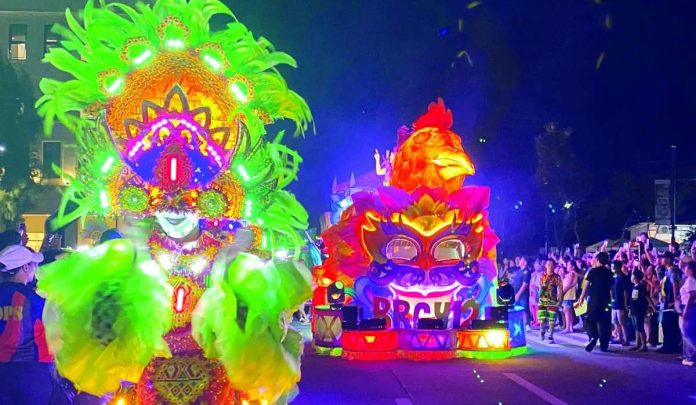 electric masskara ILLUMINATED CELEBRATION. The Chicken Inasal and San Juan float of Barangay 12 shines brightly during the Electric MassKara and Mega Float Parade at the Megaworld The Upper East in Bacolod City on Friday night, October 16. Six barangay floats and seven sponsor floats participated in this highlight event, which is one of the centerpiece attractions of the MassKara Festival 2026. CESAR JOLITO III PHOTO