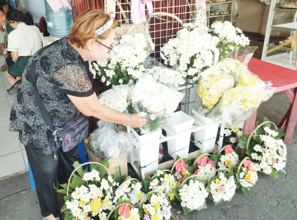 Along Rizal Street, Iloilo City, Rogelia Abella has been selling flowers for 20 years. She says prices could rise by as much as P150 on November 1, depending on supply and demand. PHOTOS BY ALLEN ANIMAS/PN