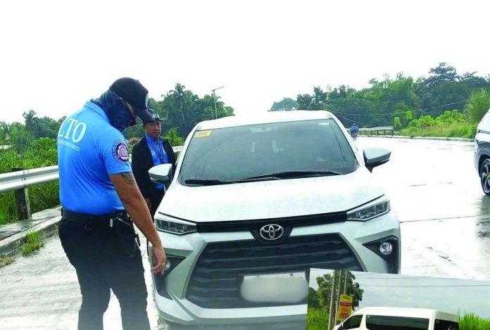 neljoy_car_rental_copy_compressed_resized A Land Transportation Office - Region 6 enforcement officer inspects a vehicle during an operation against unauthorized passenger transport. Private and rental vehicles used to ferry passengers fr a fee must have the required government franchise. LTO-6