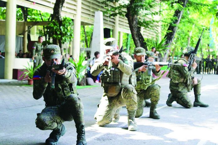 neljoy_reservists_copy_compressed_resized READY TO DEFEND, PREPARED TO RESPOND. Philippine Army reservists stand in formation and demonstrate tactical combat capabilities during the grand mustering at Iloilo Science and Technology University in La Paz, Iloilo City, on July 5, 2026. The gathering of nearly 1,300 citizen-soldiers underscored the vital role of the military reserve force in strengthening territorial defense, disaster response and emergency preparedness across Iloilo. AJ PALCULLO/PN