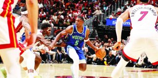 Minnesota Timberwolves superstar Anthony Edwards looks to pass against the Miami Heat during their NBA season opener. Edwards erupted for a franchise-record 45 points, including nine three-pointers, to lead Minnesota to a 131-106 victory. PHOTO BY ISSAC BALDIZON/GETTY IMAGES