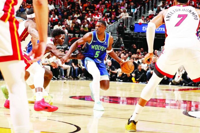 sports_Edwards_compressed_resized Minnesota Timberwolves superstar Anthony Edwards looks to pass against the Miami Heat during their NBA season opener. Edwards erupted for a franchise-record 45 points, including nine three-pointers, to lead Minnesota to a 131-106 victory. PHOTO BY ISSAC BALDIZON/GETTY IMAGES