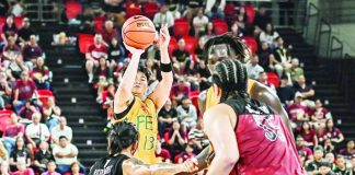 Far Eastern University Tamaraws guard Janrey Pasaol pulls up for a shot against University of the Philippines Fighting Maroons defender Rey Remogat during their UAAP Season 89 men’s basketball game. UAAP