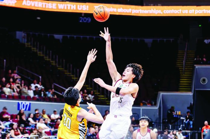 University of the Philippines Fighting Maroons’ Veejay Pre scores on a one-hander against the defense of University of Santo Tomas Growling Tigers’ Charles Esteban during their UAAP Season 89 men’s basketball encounter. UAAP