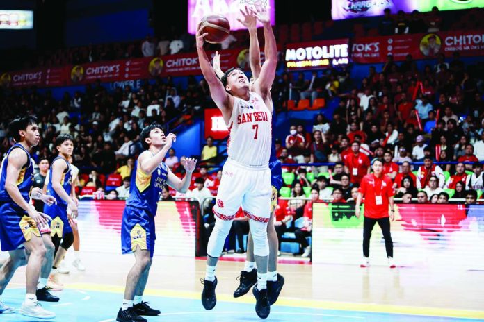 San Beda University Red Lions’ John Bismarck Lina eludes the defense of the Jose Rizal University Heavy Bombers for an inside basket during their NCAA Season 102 men’s basketball encounter. NCAA