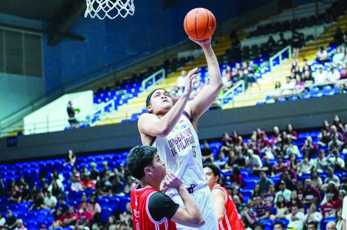 University of the Philippines Fighting Maroons center Gani Stevens attacks the basket for an inside conversion during their 101-70 rout of the University of the East Red Warriors in the UAAP Season 89 men’s basketball tournament.