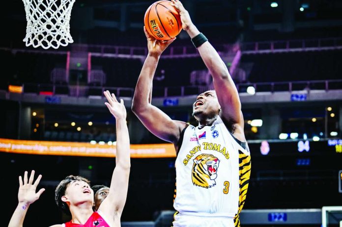 University of Santo Tomas’ Collins Akowe scores easily inside against University of the East during their UAAP Season 89 men’s basketball game at the SM Mall of Asia Arena. Akowe finished with 14 points, 11 rebounds and five blocks as the Growling Tigers prevailed, 98-87, for their second straight victory. UAAP
