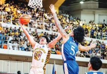 University of Santo Tomas Growling Tigers’ Kirk Cañete fends off the defense of Ateneo de Manila University Blue Eagles’ Travis Roberts as he drives for a layup during their UAAP Season 89 men’s basketball encounter. UAAP